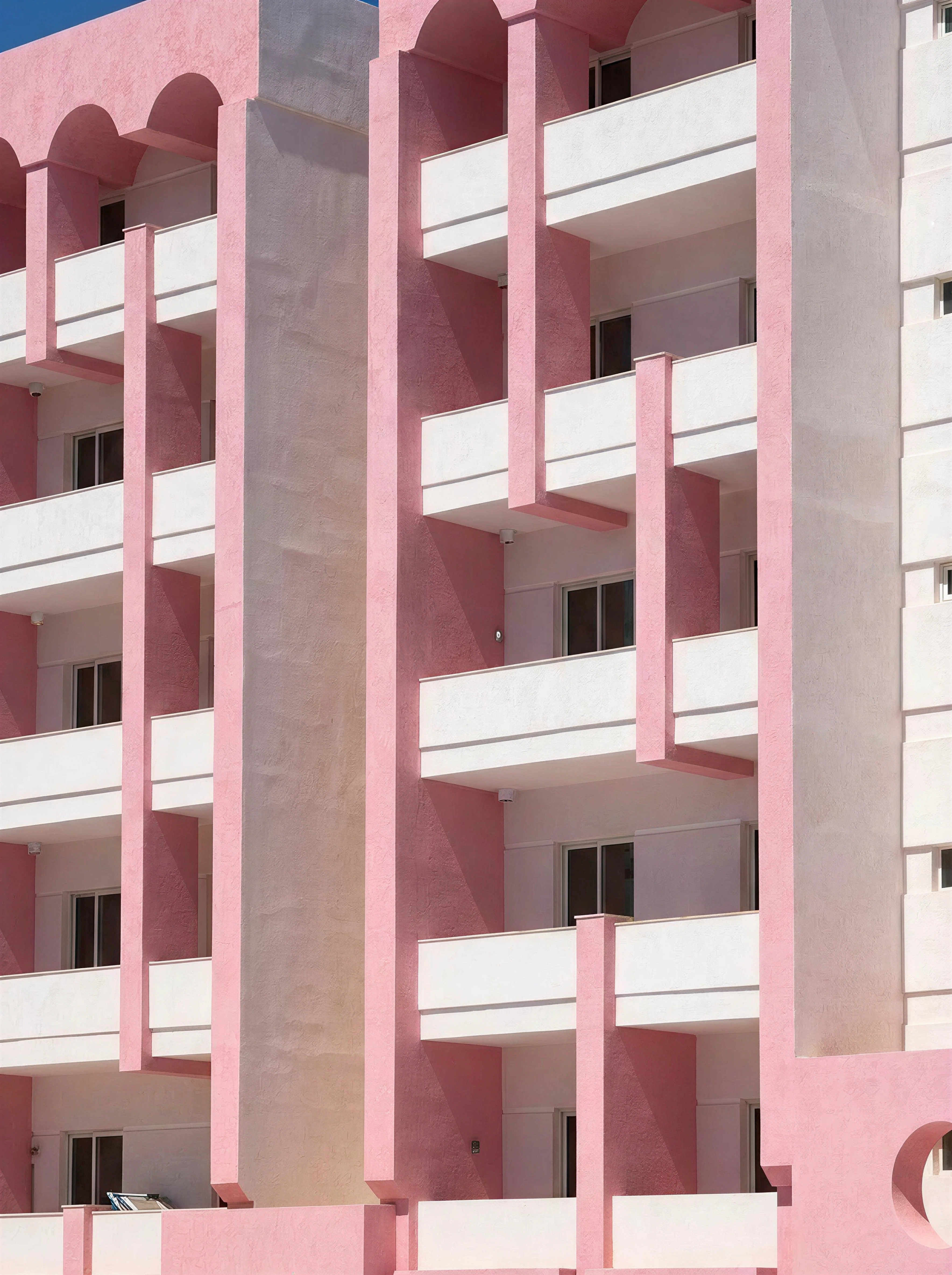 Pink arched balconies on The Flamingo building exterior, Paceville