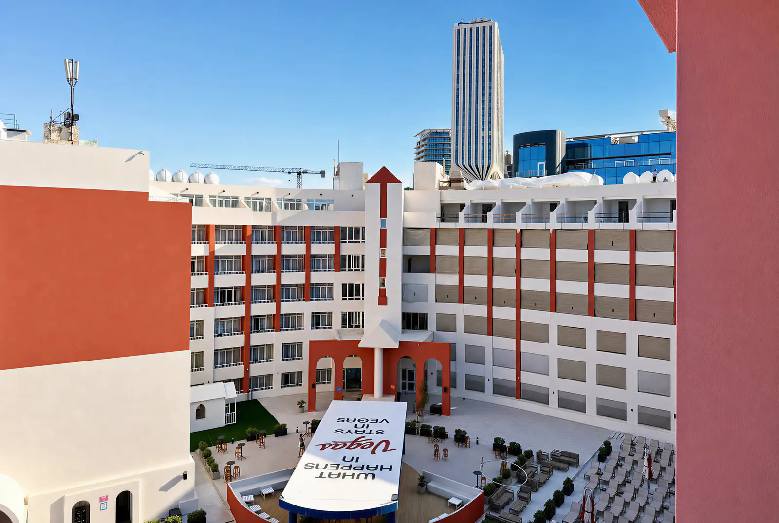 Vegas Resort courtyard with a large 'What happens in Vegas' sign, seen from above