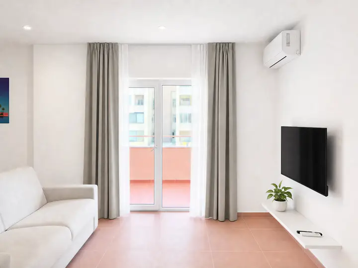 Cream sofa, wall-mounted TV above a floating shelf and glass doors to a balcony